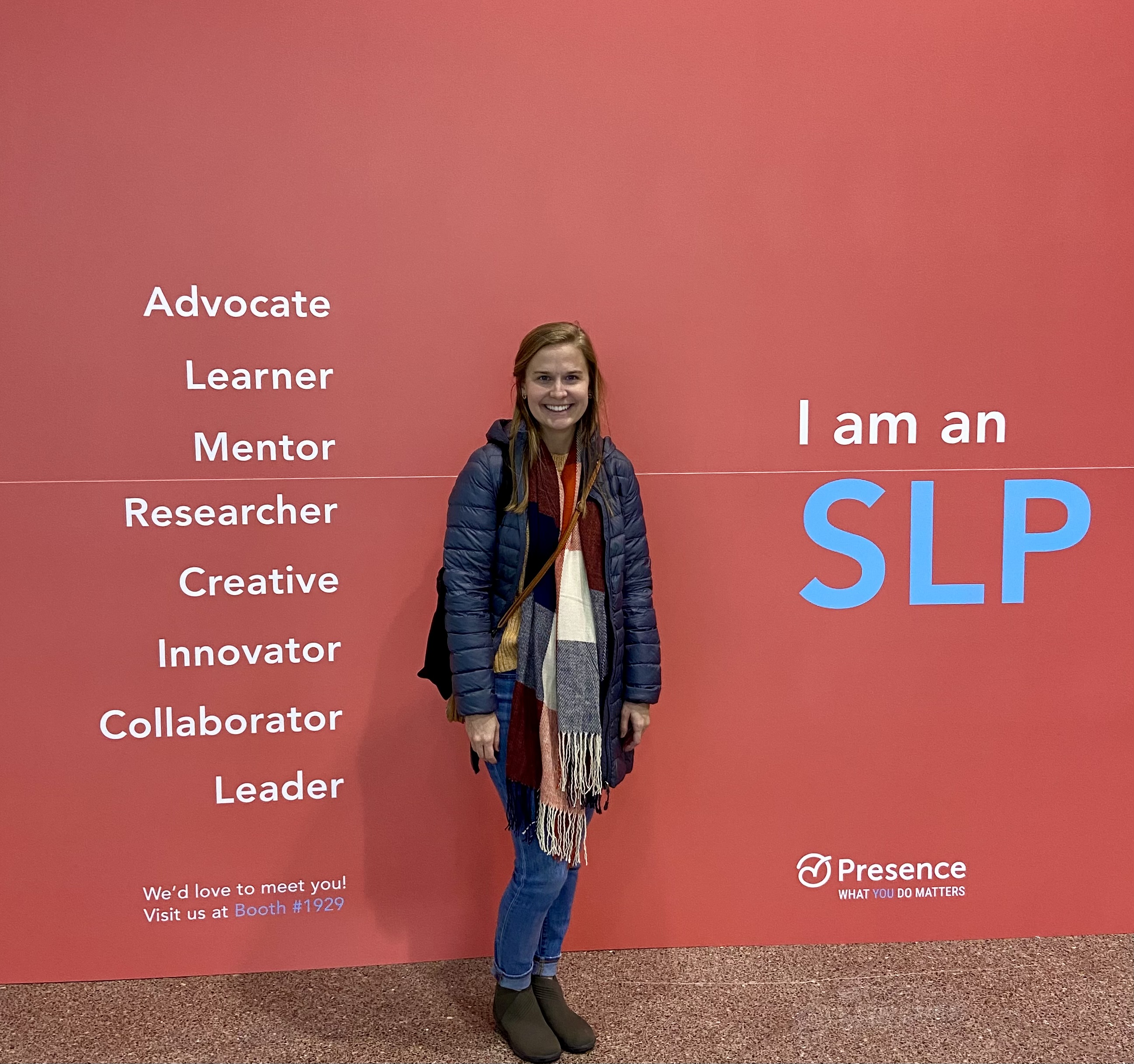Ruthie Knight in front of SLP photo wall