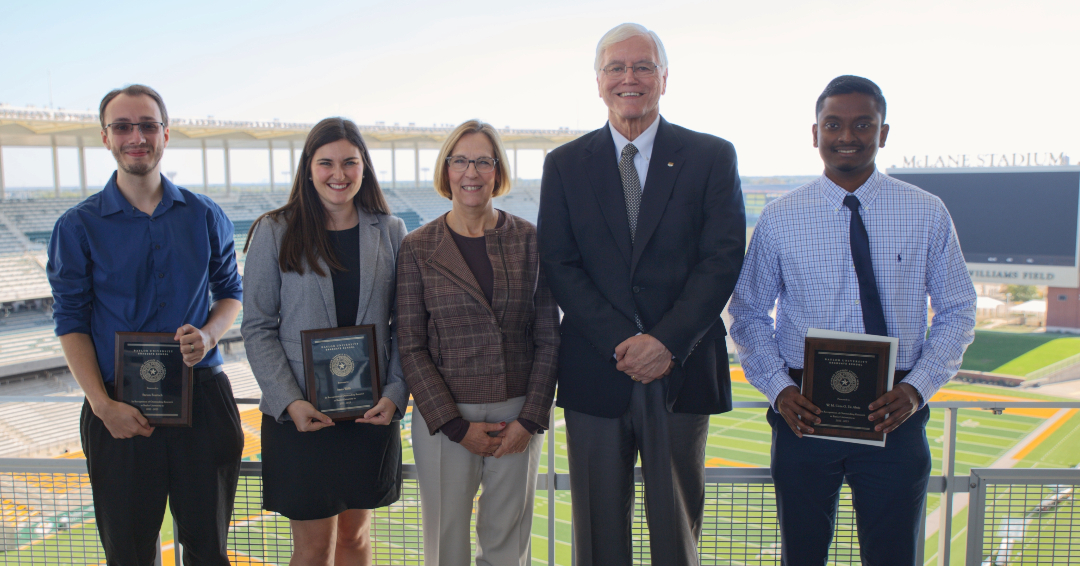 The 2023  Outstanding Graduate Student Research Award Winners stand with Provot Nancy Brickhouse and Graduate School Dean Larry Lyon with the McLane Stadium field in the background